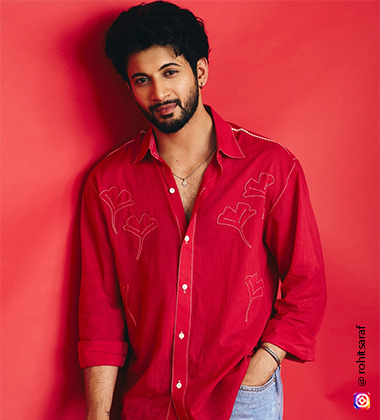 Rohit Saraf wearing a red shirt and denim jeans