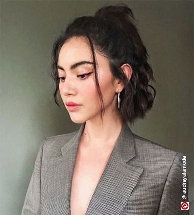 girl in a grey blazer half bun