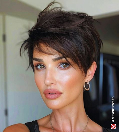 women in a sculpted pixie cut with golden hoops