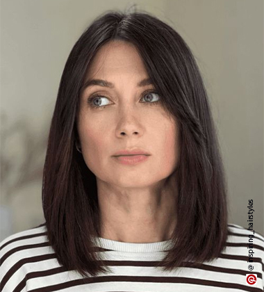 woman in black and white stripes with middle parting hair