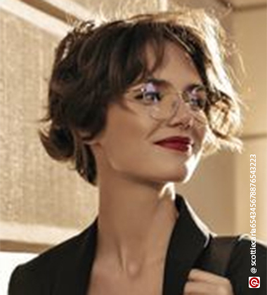 woman smiling with a red lipstick and pixie cut